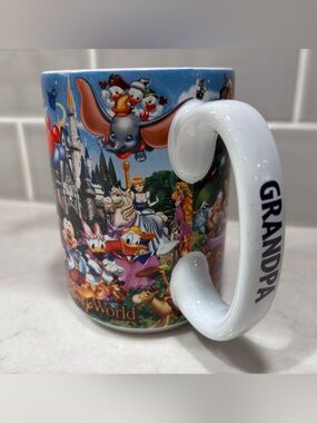 Disney World Multicolor Character Montage Mug with White 'GRANDPA' Handle